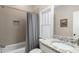 Guest bathroom with tiled shower, granite countertop, and frosted window at 275 Hampton Ne Ter, Atlanta, GA 30307