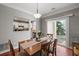 Dining room with sliding glass door to patio, table, chairs, and view to the kitchen at 3936 Hancock Cir, Atlanta, GA 30340