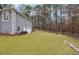 Large backyard with a sloping lawn and detached garage at 38 Timberlost Trl, Suwanee, GA 30024