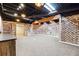 Finished basement features exposed brick, recessed lighting, and ample space at 38 Timberlost Trl, Suwanee, GA 30024