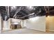 Finished basement with exposed ductwork and bar area at 38 Timberlost Trl, Suwanee, GA 30024