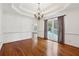 Formal dining room with hardwood floors, chandelier, and access to backyard at 38 Timberlost Trl, Suwanee, GA 30024