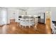 Open kitchen with large island, white cabinets, and stainless steel appliances at 38 Timberlost Trl, Suwanee, GA 30024