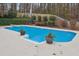 Inviting kidney-shaped pool with surrounding concrete at 38 Timberlost Trl, Suwanee, GA 30024