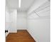 Large walk-in closet with wire shelving and hardwood floors at 38 Timberlost Trl, Suwanee, GA 30024