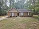Charming single-story home with a landscaped front yard and trees at 8095 Flamingo Dr, Jonesboro, GA 30238