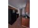 Galley kitchen with black appliances and ample counter space at 8095 Flamingo Dr, Jonesboro, GA 30238