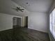 Spacious living room with dark wood-like floors and a ceiling fan at 8095 Flamingo Dr, Jonesboro, GA 30238