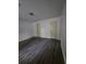 Spacious main bedroom with laminate floors and multiple doors at 8095 Flamingo Dr, Jonesboro, GA 30238