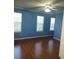 Spacious bedroom with hardwood floors and two windows at 1306 Warsaw Rd, Roswell, GA 30076