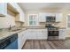 Modern kitchen with white cabinets, granite countertops, and stainless steel appliances at 876 Hutchens Se Rd, Atlanta, GA 30354