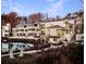 Modern townhomes with metal roofs situated around a pond at dusk at 1198 Mado Loop, Chattahoochee Hills, GA 30268