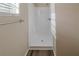 Simple, clean shower with white tile and wood-look flooring at 1275 Mill Lake Cir, Stone Mountain, GA 30088