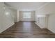 Living room with wood-look floors, a white brick fireplace, and large window at 1275 Mill Lake Cir, Stone Mountain, GA 30088