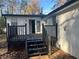 Back deck with black railing and stairs leading to the backyard at 1543 California Ave, Conley, GA 30288
