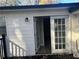 White back entrance with French doors leading to a dark wooden deck at 1543 California Ave, Conley, GA 30288