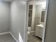 View of a bathroom through a doorway, showing vanity and tiled shower at 1543 California Ave, Conley, GA 30288