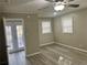 Bedroom with wood-look flooring, ceiling fan, and access to the backyard at 1543 California Ave, Conley, GA 30288