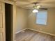 Bedroom with wood-look flooring, ceiling fan, window, and closet at 1543 California Ave, Conley, GA 30288