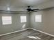 Bedroom featuring wood-look flooring, multiple windows, and a ceiling fan at 1543 California Ave, Conley, GA 30288