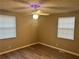 Bedroom with wood-look flooring, ceiling fan, and two windows with blinds at 1543 California Ave, Conley, GA 30288