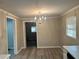 Dining room with chandelier, wood-look flooring, and neutral paint at 1543 California Ave, Conley, GA 30288