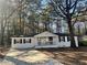 Charming white home with a covered front porch and driveway at 1543 California Ave, Conley, GA 30288