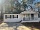 Charming white home with black shutters and covered front porch at 1543 California Ave, Conley, GA 30288