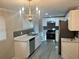 Modern kitchen with white cabinets, stainless steel appliances, and marble countertops at 1543 California Ave, Conley, GA 30288