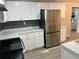 Updated kitchen with white cabinetry, marble countertops, and stainless steel appliances at 1543 California Ave, Conley, GA 30288