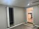 Living room with wood-look floors, a door to a room, and a view of the kitchen at 1543 California Ave, Conley, GA 30288