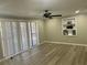 Spacious living room with wood-look floors, ceiling fan, and built-in shelving at 1543 California Ave, Conley, GA 30288