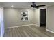 Living room featuring wood-look floors, built-in shelving, and neutral paint at 1543 California Ave, Conley, GA 30288