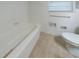 Bathroom with white tile, bathtub, and toilet at 2378 Tyler Way, Decatur, GA 30032