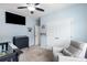 Well-lit bedroom featuring a crib, armchair, and mounted TV at 111 Bryon Ln, Acworth, GA 30102