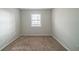 Empty bedroom with carpet and window at 4690 Big Valley Ct, Stone Mountain, GA 30083