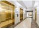 Hallway with gleaming gold elevators, marble flooring, and access to the lobby area at 1280 W Peachtree Nw St # 1003, Atlanta, GA 30309