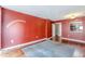 Living room with red walls, wood floors, and area rug at 1280 W Peachtree Nw St # 1003, Atlanta, GA 30309