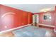 Living area with red walls, wood floors, and a large rug at 1280 W Peachtree Nw St # 1003, Atlanta, GA 30309