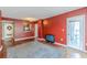 Living room with red walls, wood floors, area rug, and access to the balcony at 1280 W Peachtree Nw St # 1003, Atlanta, GA 30309