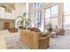 Inviting lobby space with plush sofas, coffee table, large windows, and decorative plants at 1280 W Peachtree Nw St # 1003, Atlanta, GA 30309