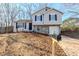 Two-story house with gray siding, stone accents, and a black mailbox at 1275 To Lani Farm Rd, Stone Mountain, GA 30083