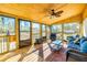 Relaxing screened porch with comfy seating and wood floors at 3625 Pointer Rd, Loganville, GA 30052