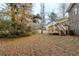 Large backyard with trees, shrubs, and a wooden deck at 450 Valley Woods Se Cir, Conyers, GA 30094