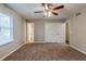 Spacious bedroom with ceiling fan, carpet, and closet at 450 Valley Woods Se Cir, Conyers, GA 30094