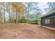 Spacious backyard with a screened-in porch and trees at 5136 Huxley Rd, Stone Mountain, GA 30088