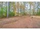 Spacious backyard surrounded by trees at 5136 Huxley Rd, Stone Mountain, GA 30088