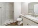 Modern bathroom with marble tile shower and granite vanity at 5136 Huxley Rd, Stone Mountain, GA 30088