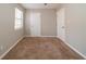 Empty bedroom with neutral colored walls and carpeting at 5136 Huxley Rd, Stone Mountain, GA 30088