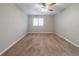 Spacious bedroom with plush carpeting, large window, ceiling fan, and neutral paint at 5136 Huxley Rd, Stone Mountain, GA 30088